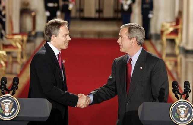 Tony Blair shaking hands with George Bush