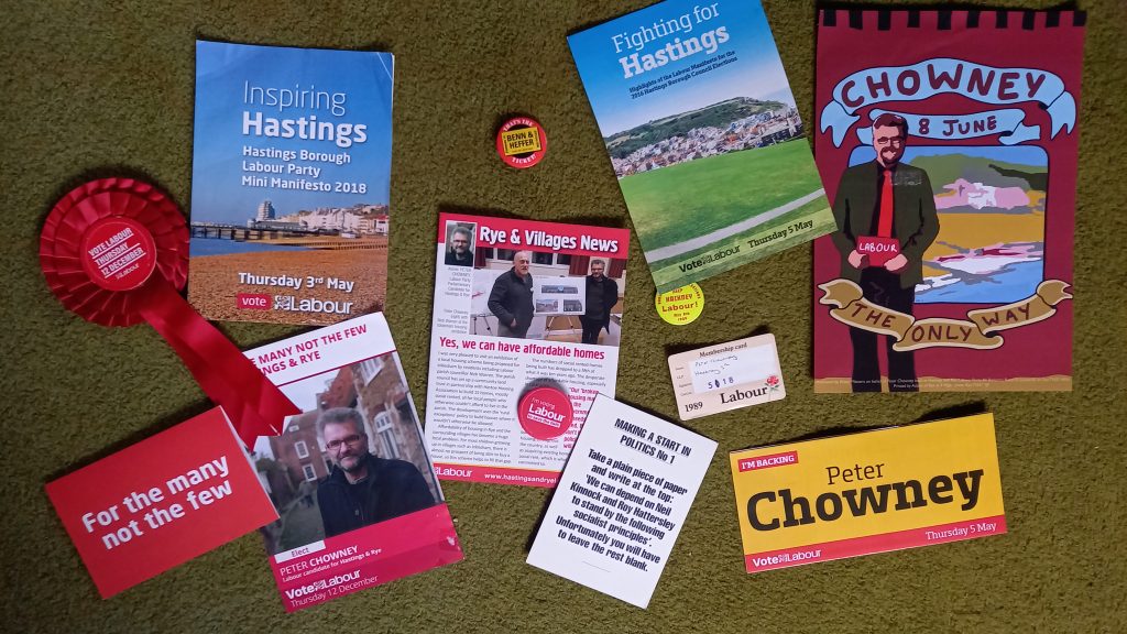 Selection of Labour election materials, badges, leaflets and rosettes, laid out on a floor