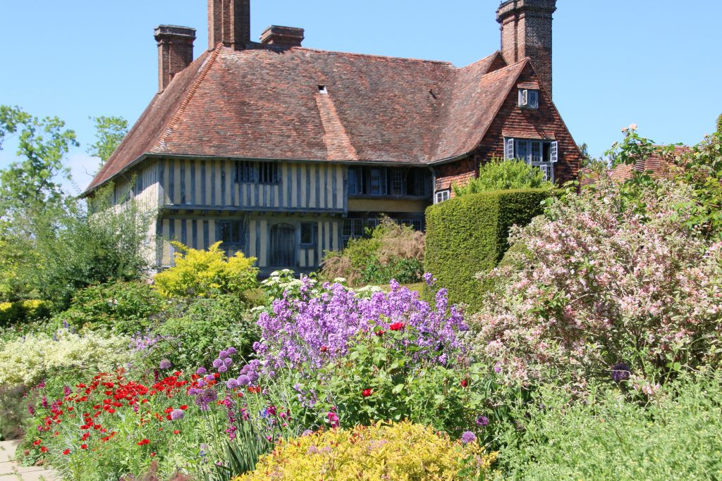 Great Dixter house with colourful floral bedding in foreground